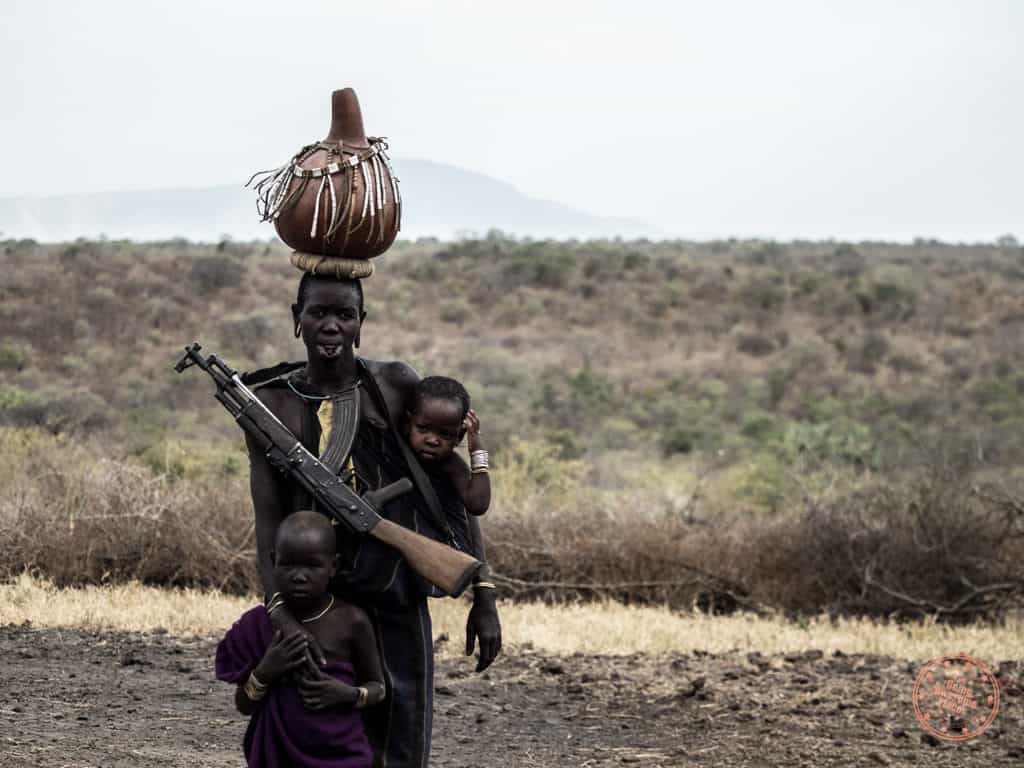 Mursi Woman with Gun and Children