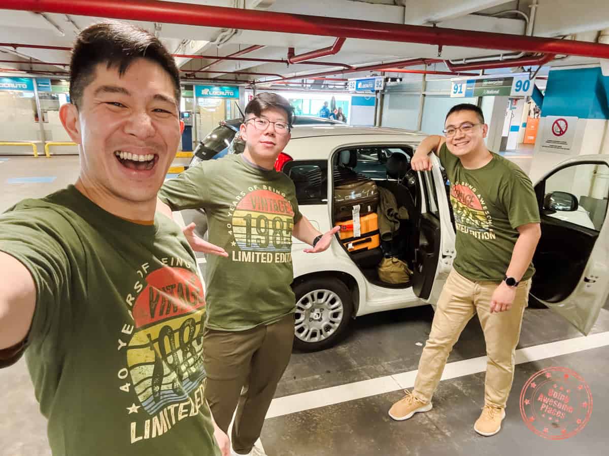 3 asian guys renting a car at fco airport in rome