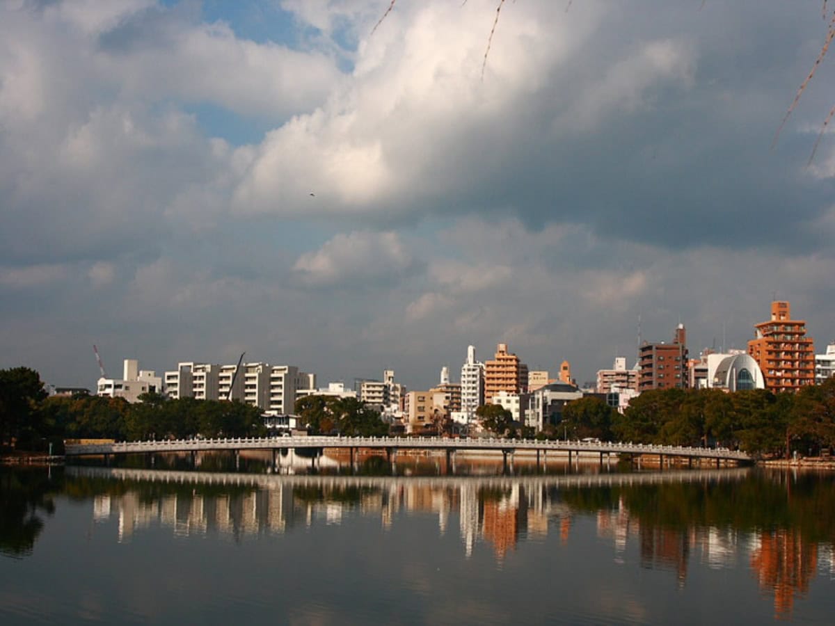view of the city of kyushu across body of water