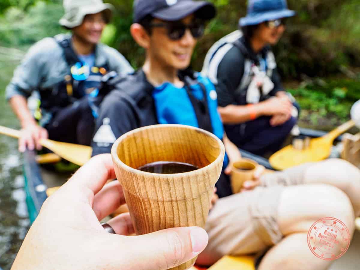 coffee break during canoe excursion on kushiro river