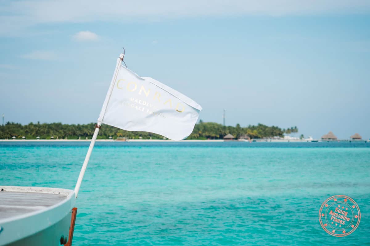 conrad maldives rangali island white flag flapping in the wind on the deck