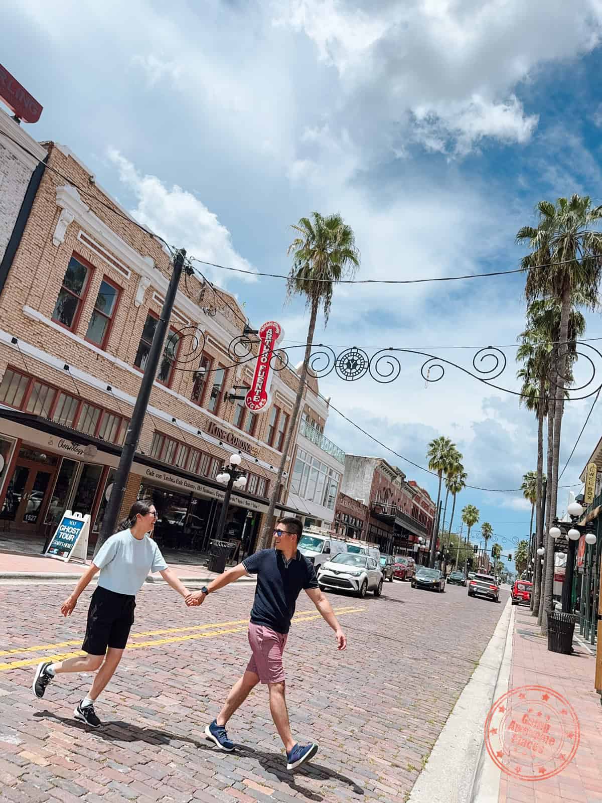 couple holding hands at ybor city streets