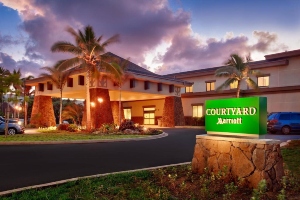 entrance of courtyard by mariott oahu north shore at sunset with sign