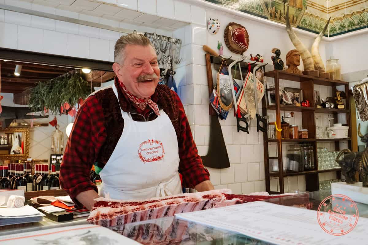 dario cecchini behind the butcher counter smiling