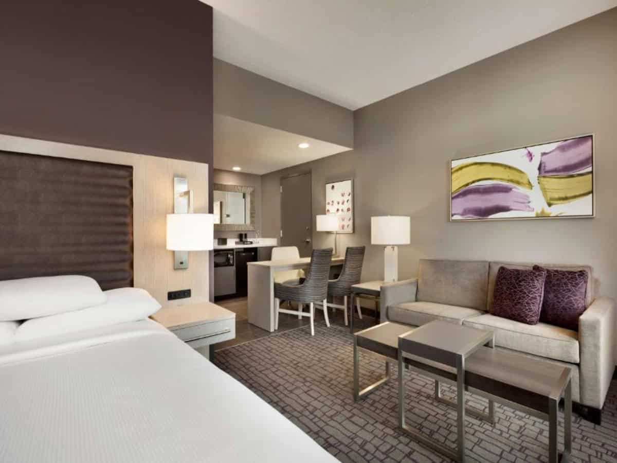 spacious room with couch seating at embassy suites by hilton charlotte uptown