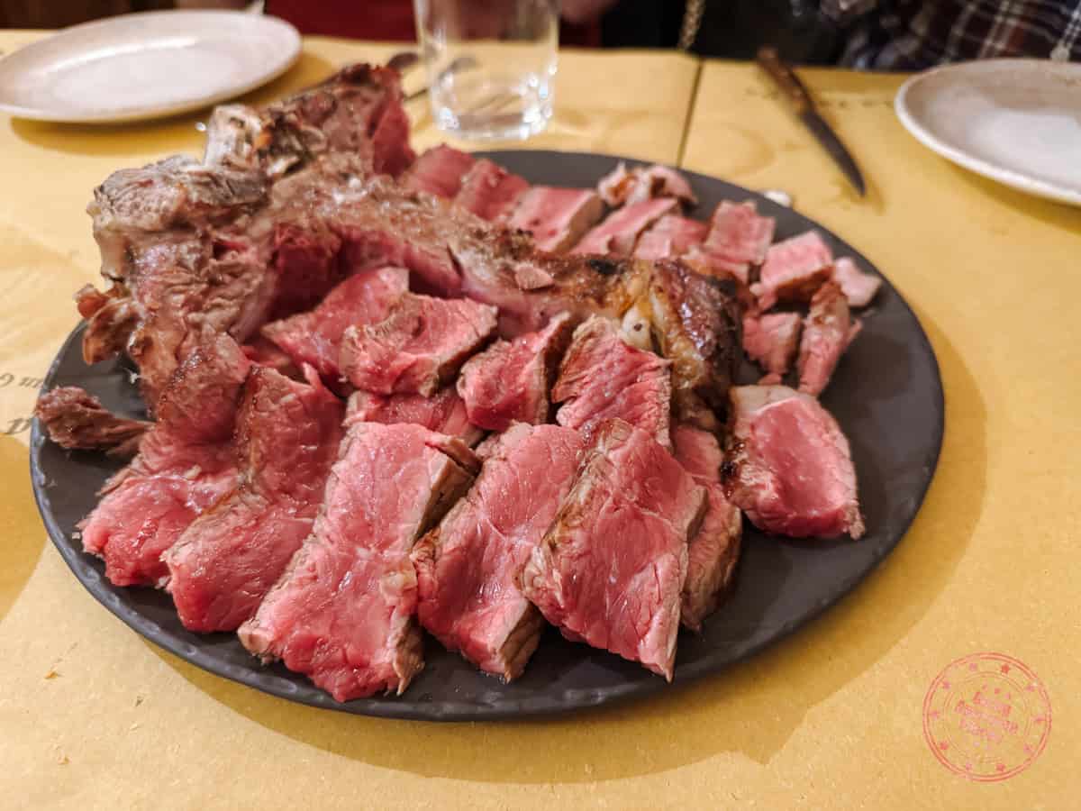 florentine steak served on a plate at taverna di san giuseppe