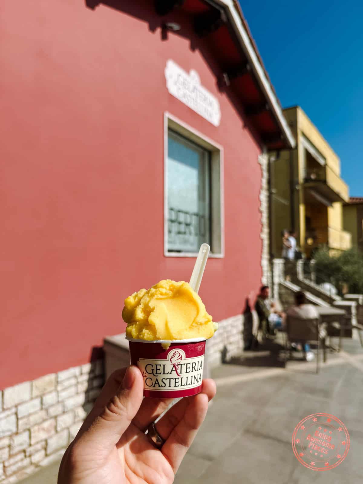 holding a cup of gelato at gelateria castellina
