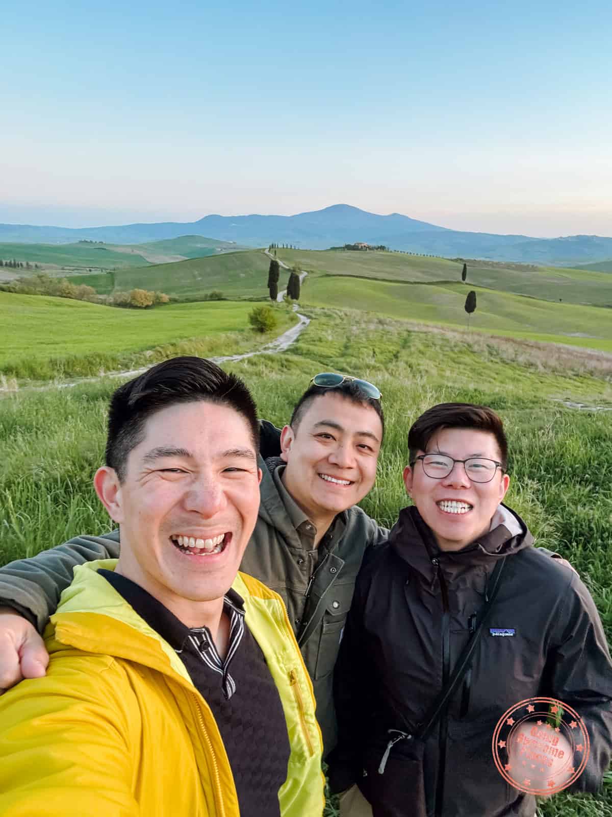 3 asian guys taking a selfie in front of podere terrapille photography location at sunset