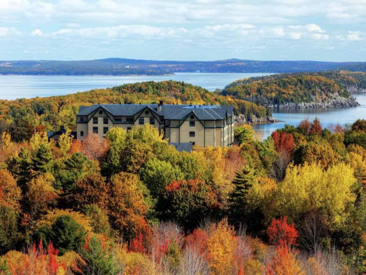 distant aerial view over hampton inn bar harbor amongst fall colored trees