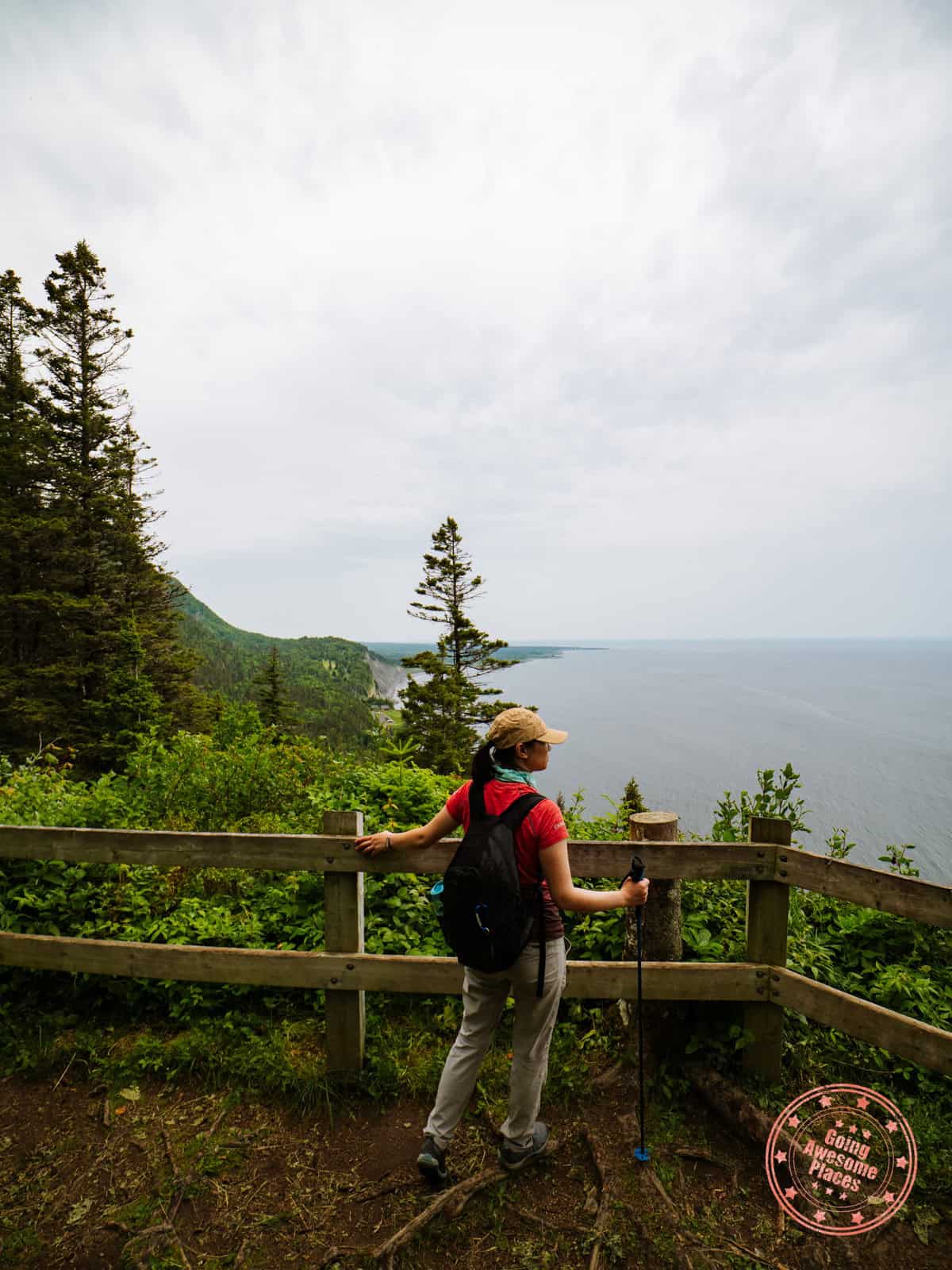 woman standing at a mont saint alban lookout point during hike
