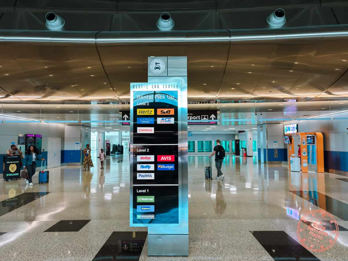 sign with list of car rental companies at miami airport