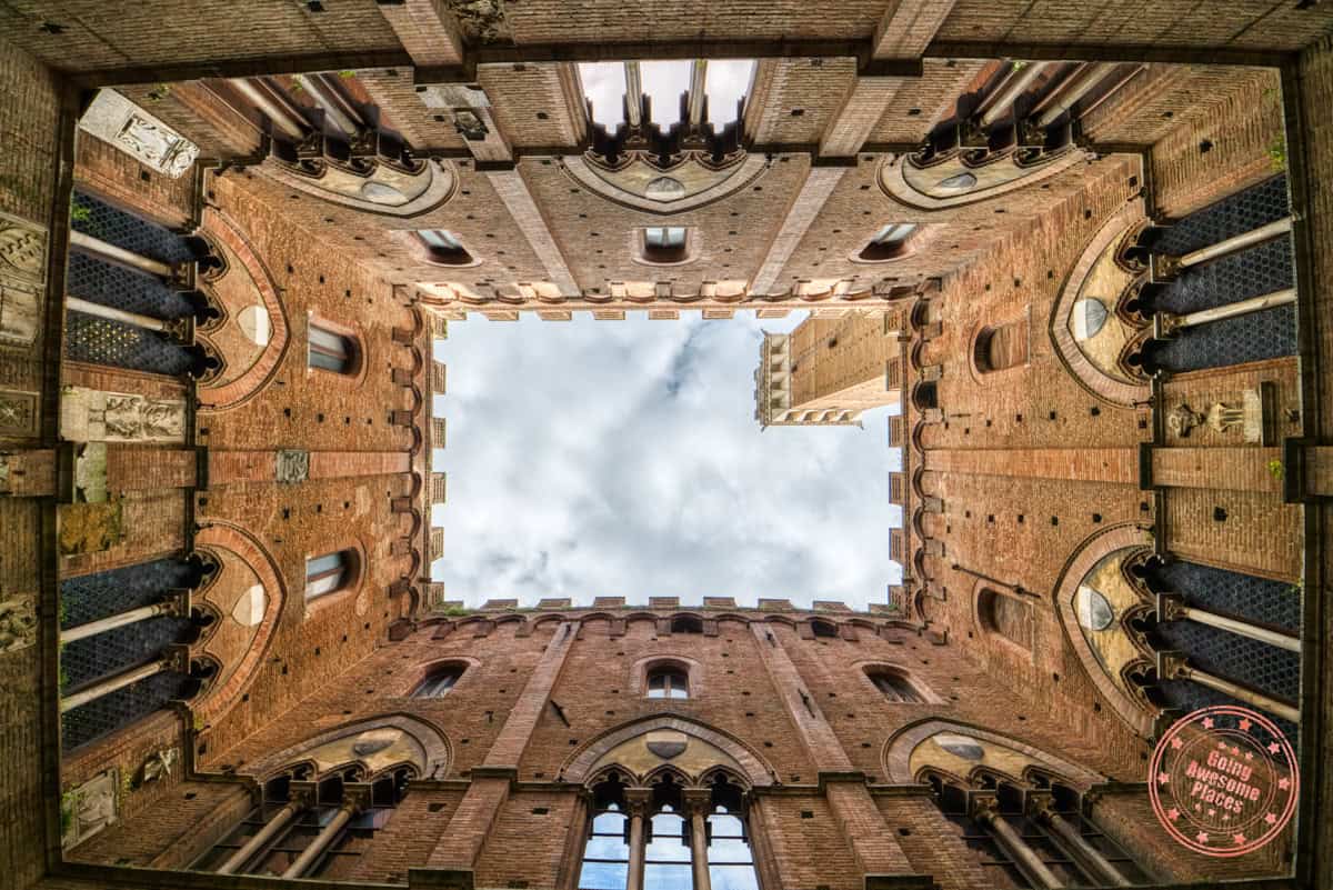 looking up at torre del mangia from inside palazzo pubblico