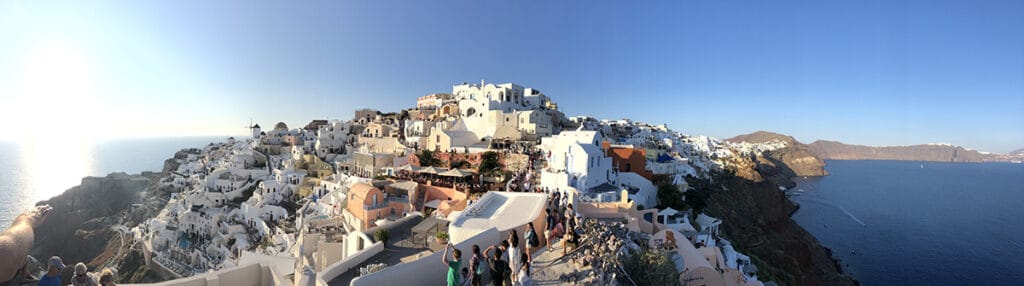 panorama of oia crowds at sunset in santorini
