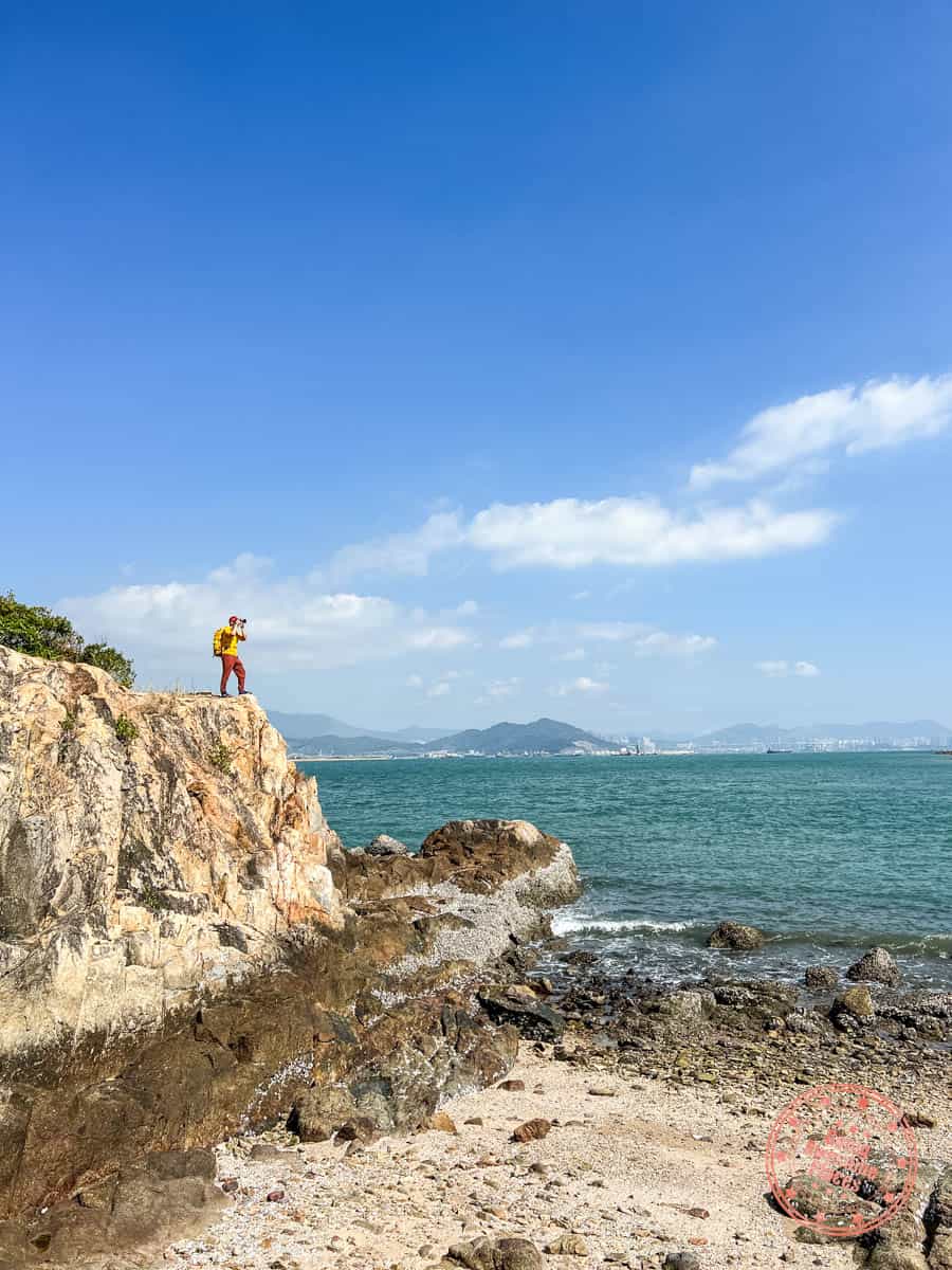 photographer on the rocks of tai lei island on peng chau