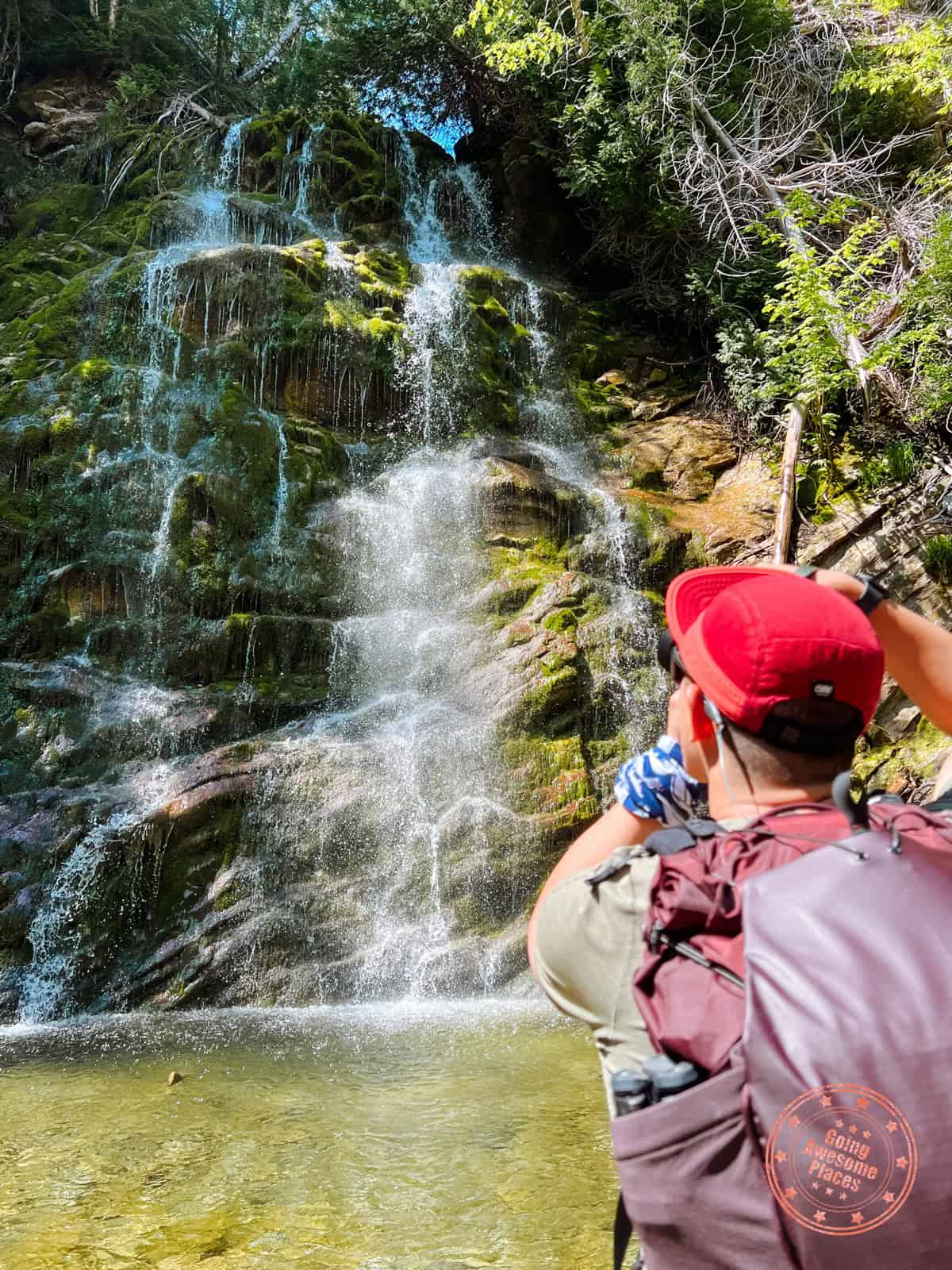 man photographing la chute inside forillon national park