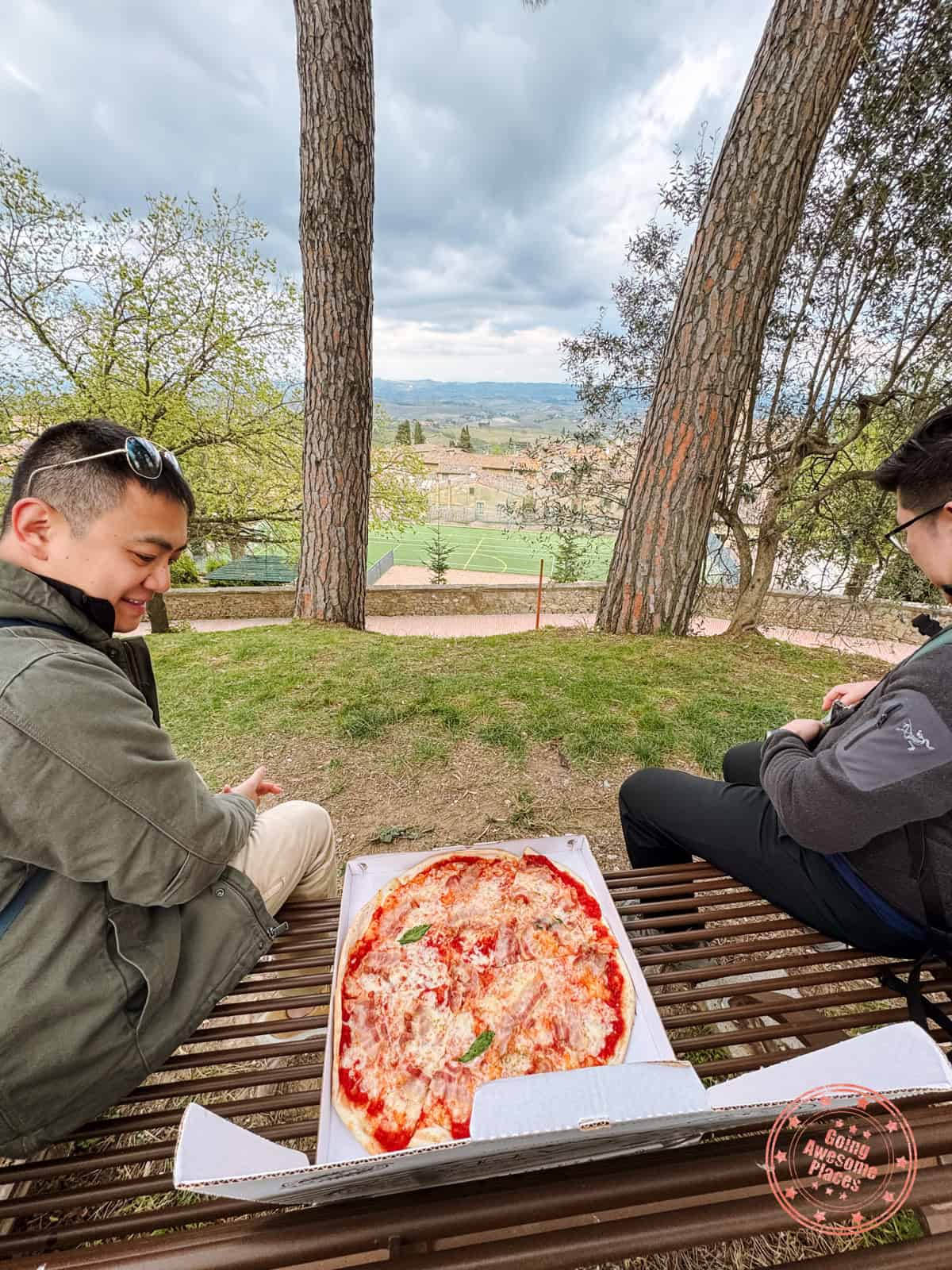 eating pizza dinner on picnic bench in san gimignano