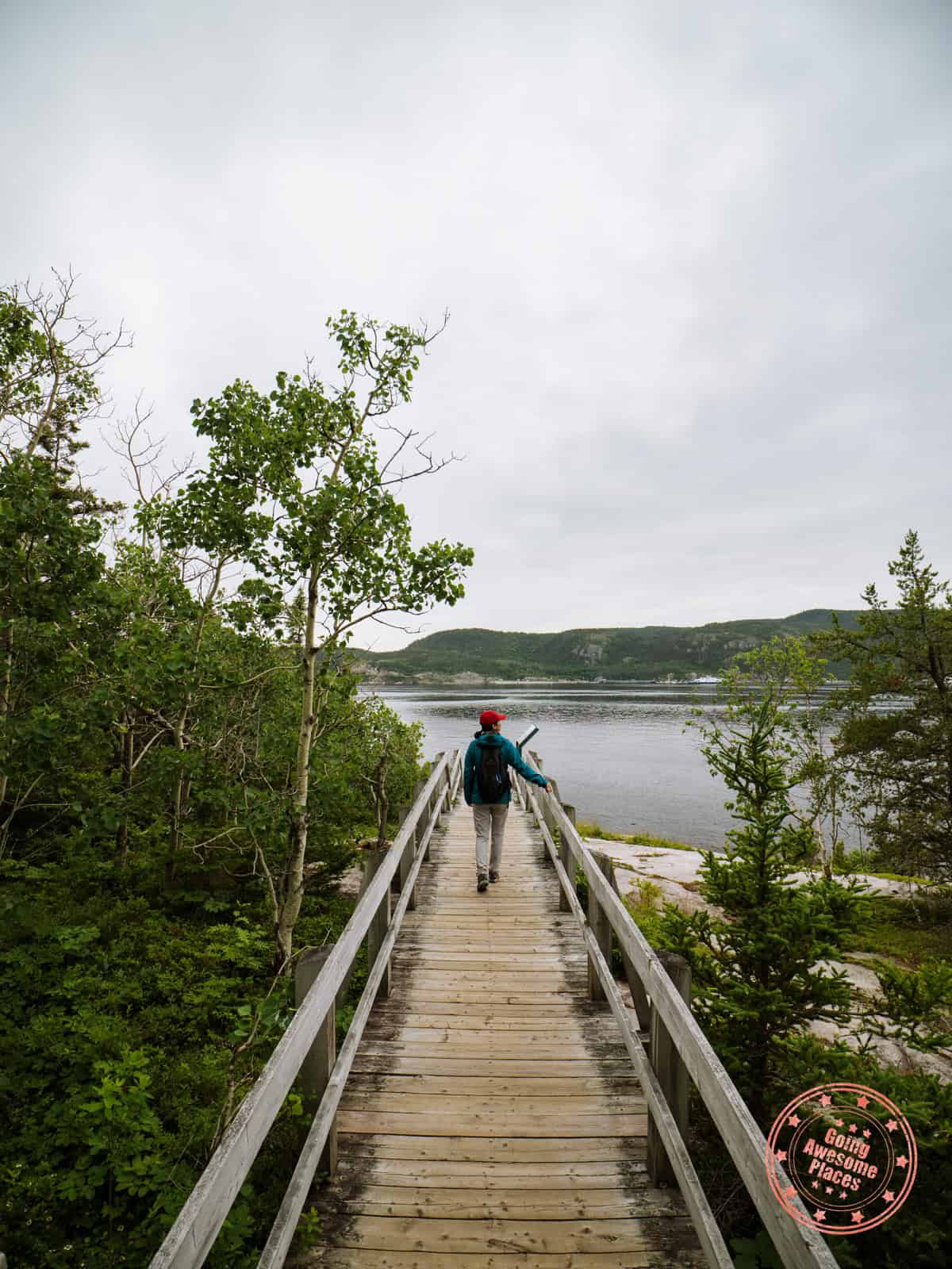 woman walking on pointe de l'islet boardwalk trail