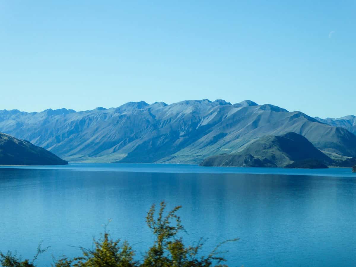 secluded lakeside view of mountain in distance