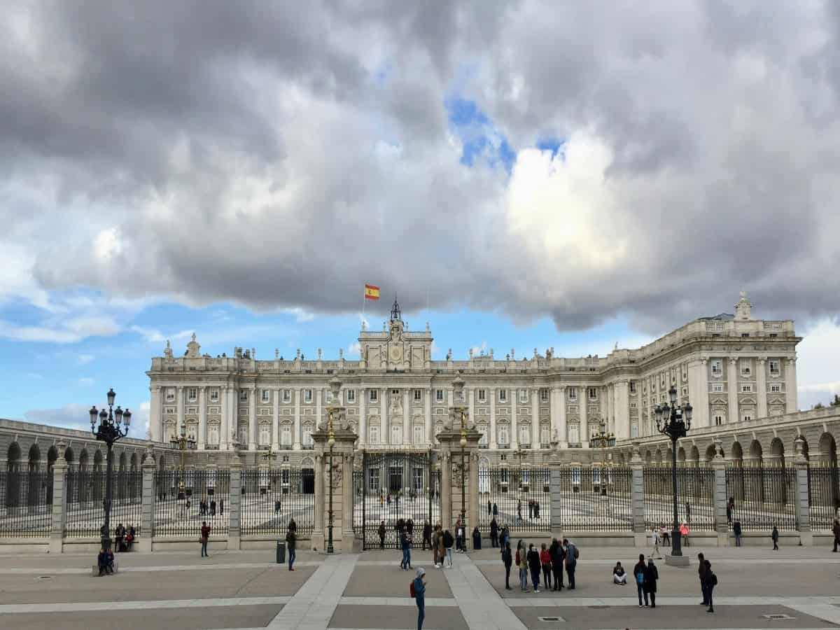 tourists exploring in front of royal palace in madrid