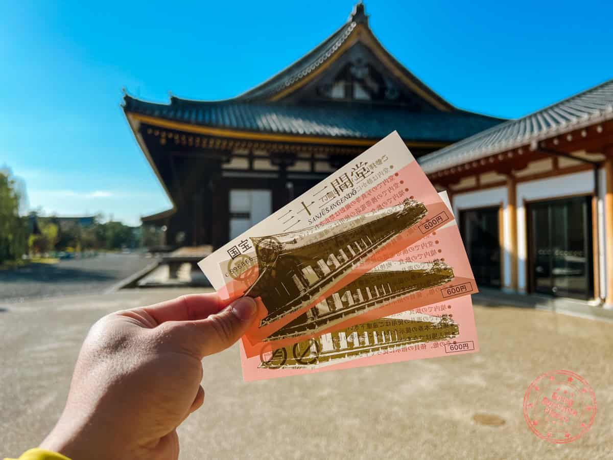 sanjusangendo temple holding three entrance tickets