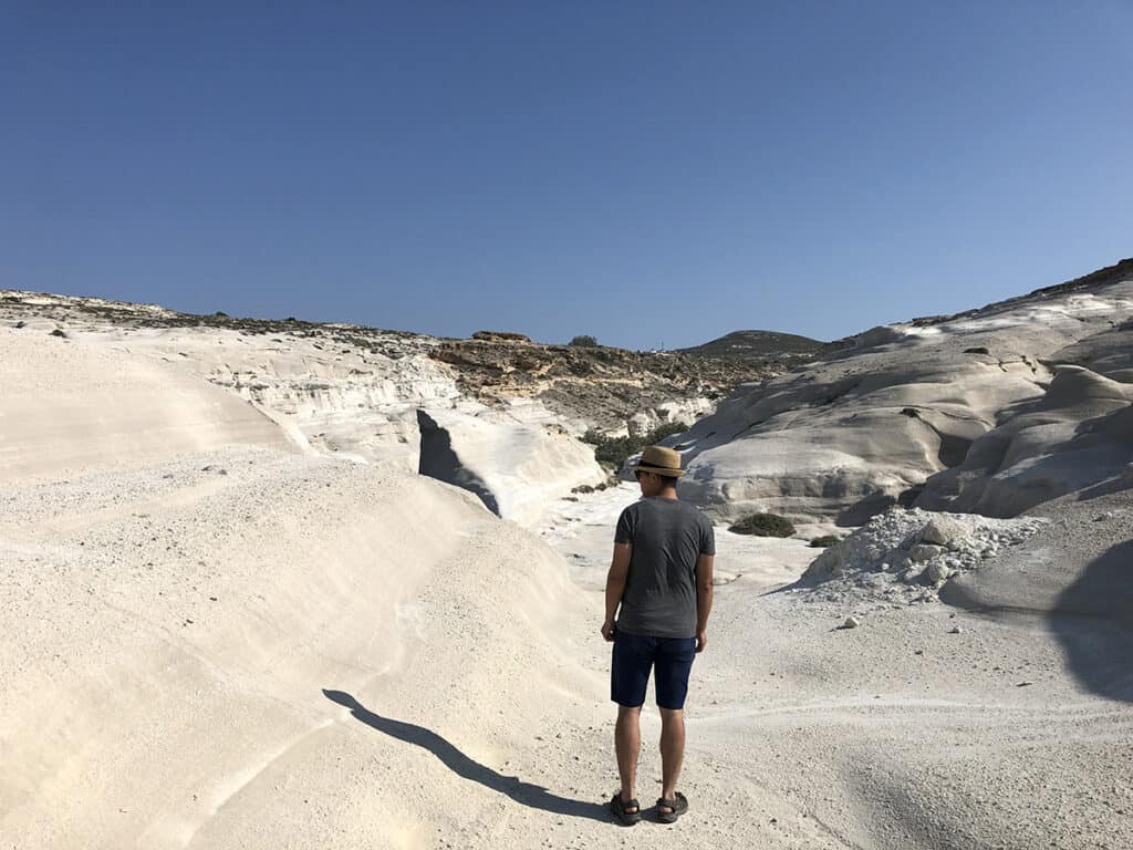 walking in the lunar landscape of sarakiniko beach in milos