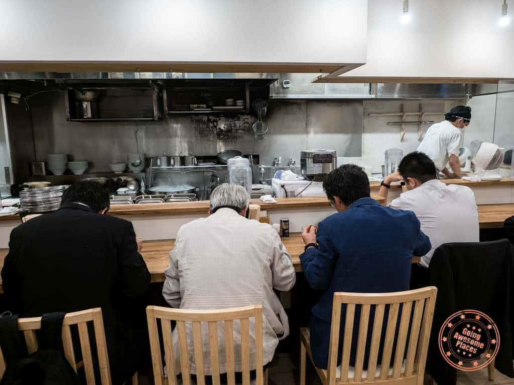 shichisai business men eating ramen