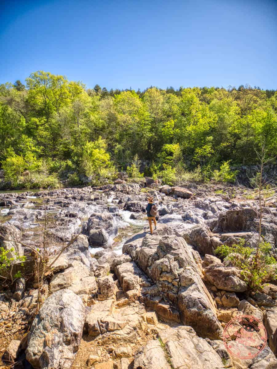 woman standing on rock of johnson's shut-ins state park