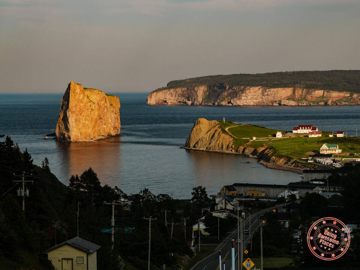 sun shining on perce rock at sunset