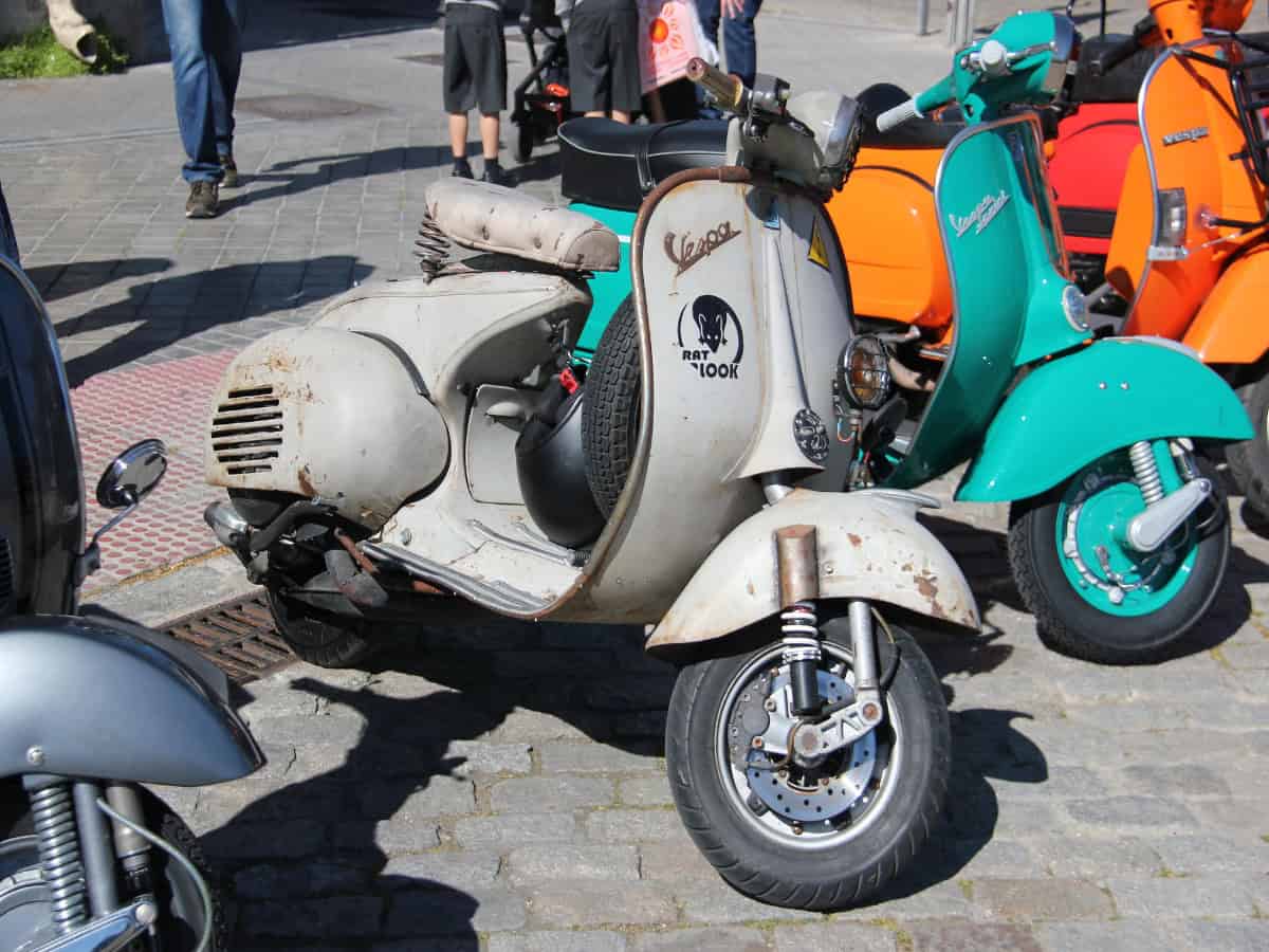 vespa scooters parked along street in madrid