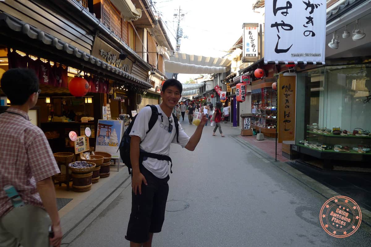 walking down street with filled with markets 