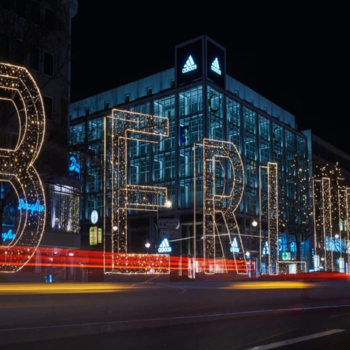 large "berlin" light lit up at night in front of city building