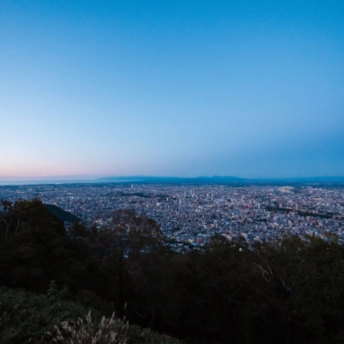 aerial view over city of sapporo under a clear blue sky