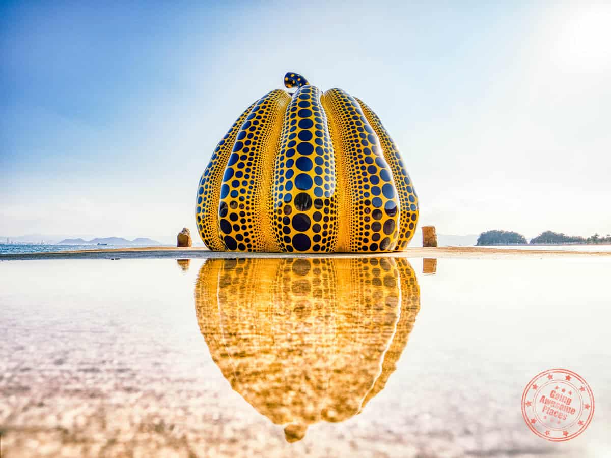yayoi kusama yellow pumpkin reflected in water on naoshima island